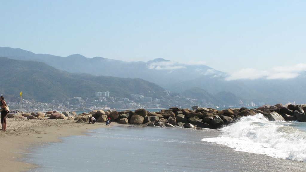 Calm beach shoreline with mountains